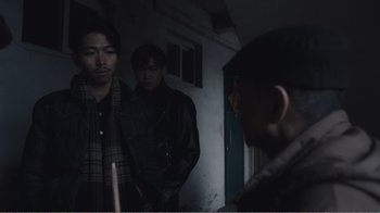 Movie still from “An Elephant Sitting Still” (2018), directed by Bo Hu – A group of men standing next to each other in a room; Medium shot, Over the shoulder angle