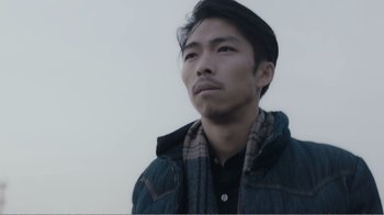 Movie still from “An Elephant Sitting Still” (2018), directed by Bo Hu – A man with a beard is looking at the camera; Close Up shot, Low angle