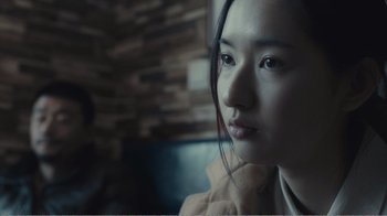 Movie still from “An Elephant Sitting Still” (2018), directed by Bo Hu – A person sitting in a chair; Close Up shot, Over the shoulder angle