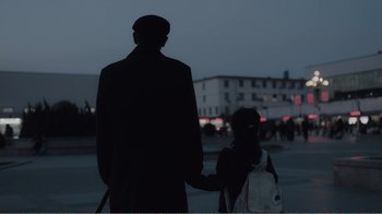 Movie still from “An Elephant Sitting Still” (2018), directed by Bo Hu – A man and a woman holding hands in the middle of the night; Medium shot, Low angle