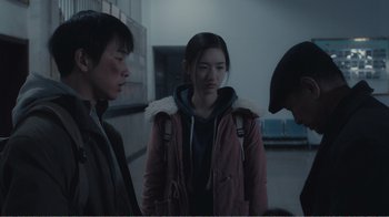 Movie still from “An Elephant Sitting Still” (2018), directed by Bo Hu – A group of people standing next to each other in a room; Medium shot, Over the shoulder angle