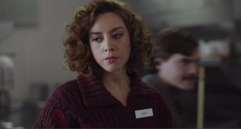 Movie still from “An Evening with Beverly Luff Linn” (2018), directed by Jim Hosking – A woman in a red sweater is looking to her left; Close Up shot, Over the shoulder angle
