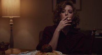Movie still from “An Evening with Beverly Luff Linn” (2018), directed by Jim Hosking – A woman sitting in front of a plate of spaghetti and meatballs; Medium shot, Over the shoulder angle