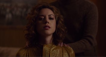 Movie still from “An Evening with Beverly Luff Linn” (2018), directed by Jim Hosking – A beautiful woman with curly hair and a yellow dress; Close Up shot, Low angle