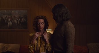 Movie still from “An Evening with Beverly Luff Linn” (2018), directed by Jim Hosking – A woman standing next to a man in a room; Medium shot, Over the shoulder angle