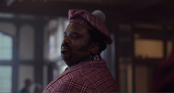 Movie still from “An Evening with Beverly Luff Linn” (2018), directed by Jim Hosking – A man with a beard wearing a hat and a jacket; Close Up shot, Low angle