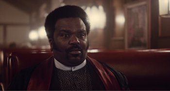 Movie still from “An Evening with Beverly Luff Linn” (2018), directed by Jim Hosking – A person sitting on a chair; Close Up shot, Over the shoulder angle