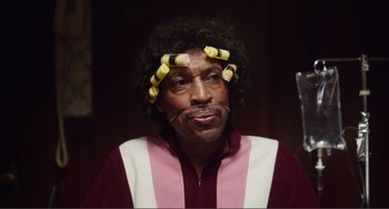 Movie still from “An Evening with Beverly Luff Linn” (2018), directed by Jim Hosking – A man with hair curlers on his head; Close Up shot, Low angle