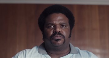 Movie still from “An Evening with Beverly Luff Linn” (2018), directed by Jim Hosking – A person wearing a shirt; Close Up shot, Low angle