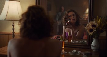 Movie still from “An Evening with Beverly Luff Linn” (2018), directed by Jim Hosking – A woman sitting in front of a bathroom mirror; Medium shot, Over the shoulder angle