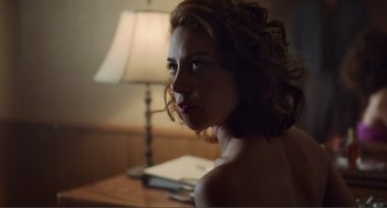 Movie still from “An Evening with Beverly Luff Linn” (2018), directed by Jim Hosking – A beautiful woman sitting in front of a lamp; Close Up shot, Over the shoulder angle