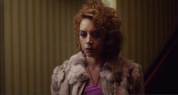 Movie still from “An Evening with Beverly Luff Linn” (2018), directed by Jim Hosking – A woman with red hair wearing a pink fur coat; Close Up shot, Low angle