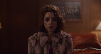 Movie still from “An Evening with Beverly Luff Linn” (2018), directed by Jim Hosking – A woman in a pink fur coat looking at the camera; Close Up shot, Over the shoulder angle