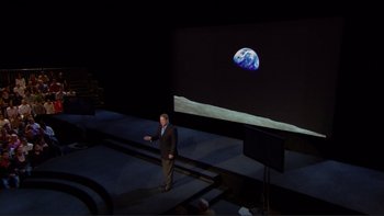 Movie still from “An Inconvenient Truth” (2006), directed by Davis Guggenheim – A man standing in front of a projection of the earth; Wide shot, High angle