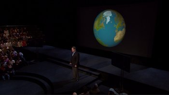 Movie still from “An Inconvenient Truth” (2006), directed by Davis Guggenheim – A man standing in front of a projection of the earth; Extreme Wide shot, High angle