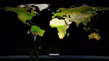 Movie still from “An Inconvenient Truth” (2006), directed by Davis Guggenheim – A man standing in front of a large map of the world; Wide shot, Overhead angle
