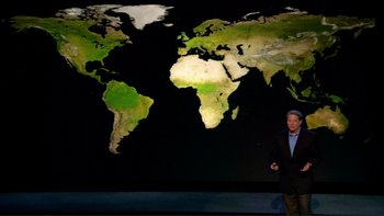Movie still from “An Inconvenient Truth” (2006), directed by Davis Guggenheim – A man standing in front of a large map of the world; Wide shot, Overhead angle