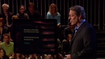 Movie still from “An Inconvenient Truth” (2006), directed by Davis Guggenheim – A man standing in front of a crowd of people in front of a screen; Medium shot, Over the shoulder angle