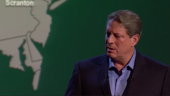 Movie still from “An Inconvenient Truth” (2006), directed by Davis Guggenheim – A man in a black suit and a blue shirt; Close Up shot, Low angle