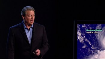 Movie still from “An Inconvenient Truth” (2006), directed by Davis Guggenheim – A man standing in front of a television; Medium shot, Low angle