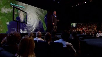 Movie still from “An Inconvenient Truth” (2006), directed by Davis Guggenheim – A man standing on a stage in front of an audience; Wide shot, High angle