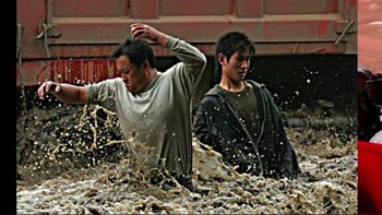 Movie still from “An Inconvenient Truth” (2006), directed by Davis Guggenheim – Two men are standing in a pile of water; Wide shot, High angle