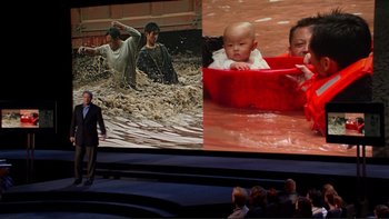 Movie still from “An Inconvenient Truth” (2006), directed by Davis Guggenheim – A man standing in front of a large screen; Wide shot, High angle