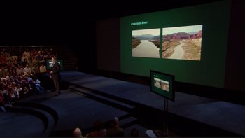 Movie still from “An Inconvenient Truth” (2006), directed by Davis Guggenheim – A man standing in front of a large screen; Extreme Wide shot, High angle