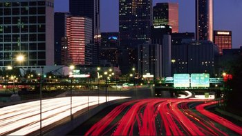 Movie still from “An Inconvenient Truth” (2006), directed by Davis Guggenheim – A city street at night lit up by street lights; Extreme Wide shot, Low angle