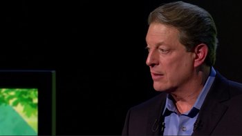 Movie still from “An Inconvenient Truth” (2006), directed by Davis Guggenheim – A person wearing a suit and tie; Close Up shot, Over the shoulder angle