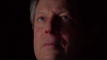 Movie still from “An Inconvenient Truth” (2006), directed by Davis Guggenheim – A person's face with a dark background; Close Up shot, Low angle
