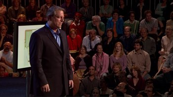 Movie still from “An Inconvenient Truth” (2006), directed by Davis Guggenheim – A man standing in front of a crowd of people; Wide shot, Over the shoulder angle