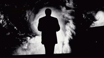 Movie still from “An Inconvenient Truth” (2006), directed by Davis Guggenheim – A man standing in front of a cloud of smoke; Medium shot, Low angle