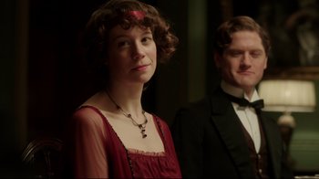 Movie still from “An Inspector Calls” (2015), directed by Raymond Pak-Ming Wong – A woman in a red dress standing next to a man in a black suit; Close Up shot, Over the shoulder angle