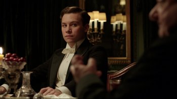 Movie still from “An Inspector Calls” (2015), directed by Raymond Pak-Ming Wong – A man in a tuxedo sitting at a table; Close Up shot, Over the shoulder angle