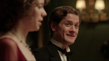 Movie still from “An Inspector Calls” (2015), directed by Raymond Pak-Ming Wong – A man in a tuxedo and a woman in a black dress; Close Up shot, Over the shoulder angle