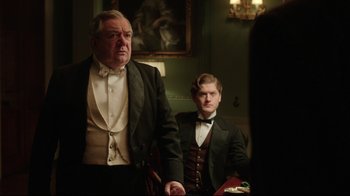 Movie still from “An Inspector Calls” (2015), directed by Raymond Pak-Ming Wong – Two men dressed in formal attire in a room; Medium shot, Over the shoulder angle