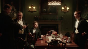 Movie still from “An Inspector Calls” (2015), directed by Raymond Pak-Ming Wong – Two men sitting at a dinner table in formal wear; Medium shot, Low angle