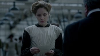 Movie still from “An Inspector Calls” (2015), directed by Raymond Pak-Ming Wong – A woman holding a piece of paper while standing next to another person; Close Up shot, Over the shoulder angle