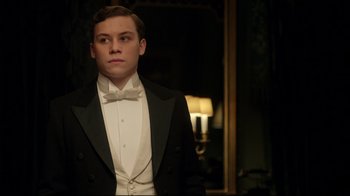 Movie still from “An Inspector Calls” (2015), directed by Raymond Pak-Ming Wong – A man in a tuxedo standing in front of a mirror; Medium shot, Low angle