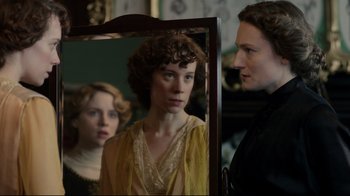 Movie still from “An Inspector Calls” (2015), directed by Raymond Pak-Ming Wong – A woman standing in front of a mirror looking at herself in the mirror; Close Up shot, Over the shoulder angle