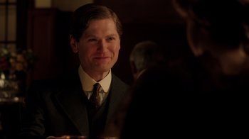 Movie still from “An Inspector Calls” (2015), directed by Raymond Pak-Ming Wong – A man wearing a suit and tie in front of a mirror; Close Up shot, Over the shoulder angle