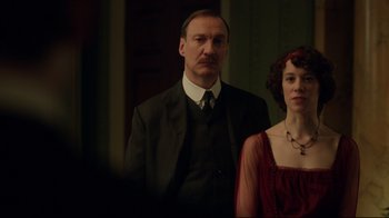 Movie still from “An Inspector Calls” (2015), directed by Raymond Pak-Ming Wong – A man and a woman standing next to each other; Medium shot, Low angle