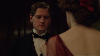 Movie still from “An Inspector Calls” (2015), directed by Raymond Pak-Ming Wong – A man in a tuxedo looking at a woman in a red dress; Close Up shot, Over the shoulder angle
