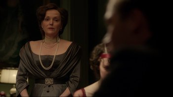Movie still from “An Inspector Calls” (2015), directed by Raymond Pak-Ming Wong – A woman in a black dress is looking in the mirror; Medium shot, Over the shoulder angle