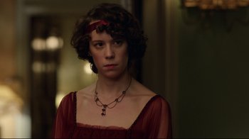 Movie still from “An Inspector Calls” (2015), directed by Raymond Pak-Ming Wong – A woman in a red dress with a red ribbon around her neck; Close Up shot, Over the shoulder angle