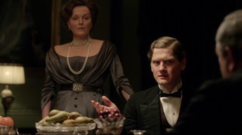 Movie still from “An Inspector Calls” (2015), directed by Raymond Pak-Ming Wong – A man and a woman sitting in front of a bowl of fruit; Medium shot, Over the shoulder angle