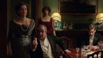 Movie still from “An Inspector Calls” (2015), directed by Raymond Pak-Ming Wong – A man sitting at a dinner table with two women; Medium shot, Over the shoulder angle