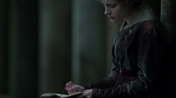 Movie still from “An Inspector Calls” (2015), directed by Raymond Pak-Ming Wong – A woman writing in a notebook with a pen; Medium shot, High angle