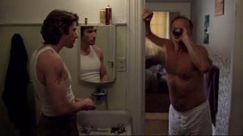 Movie still from “An Officer and a Gentleman” (1982), directed by Taylor Hackford – Two men in their underwear looking in a bathroom mirror; Medium shot, Low angle